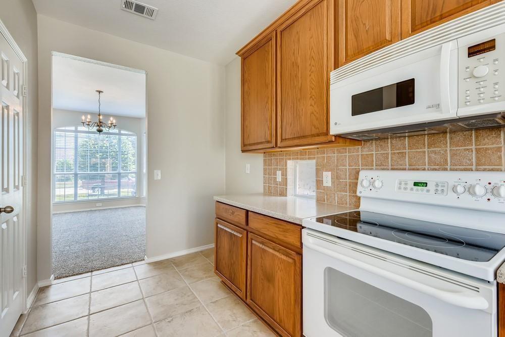 9937 Appletree Way Fort Worth, TX 76244 - Photo 6 of 25 a kitchen with stainless steel appliances a sink and a microwave
