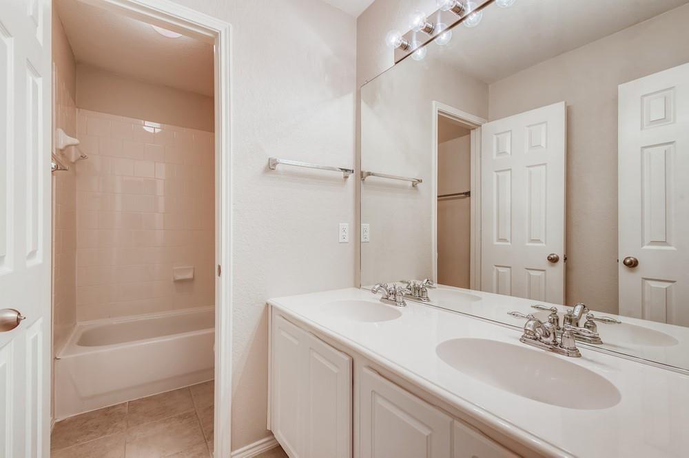 9937 Appletree Way Fort Worth, TX 76244 - Photo 10 of 25 a bathroom with a tub sink vanity granite and shower