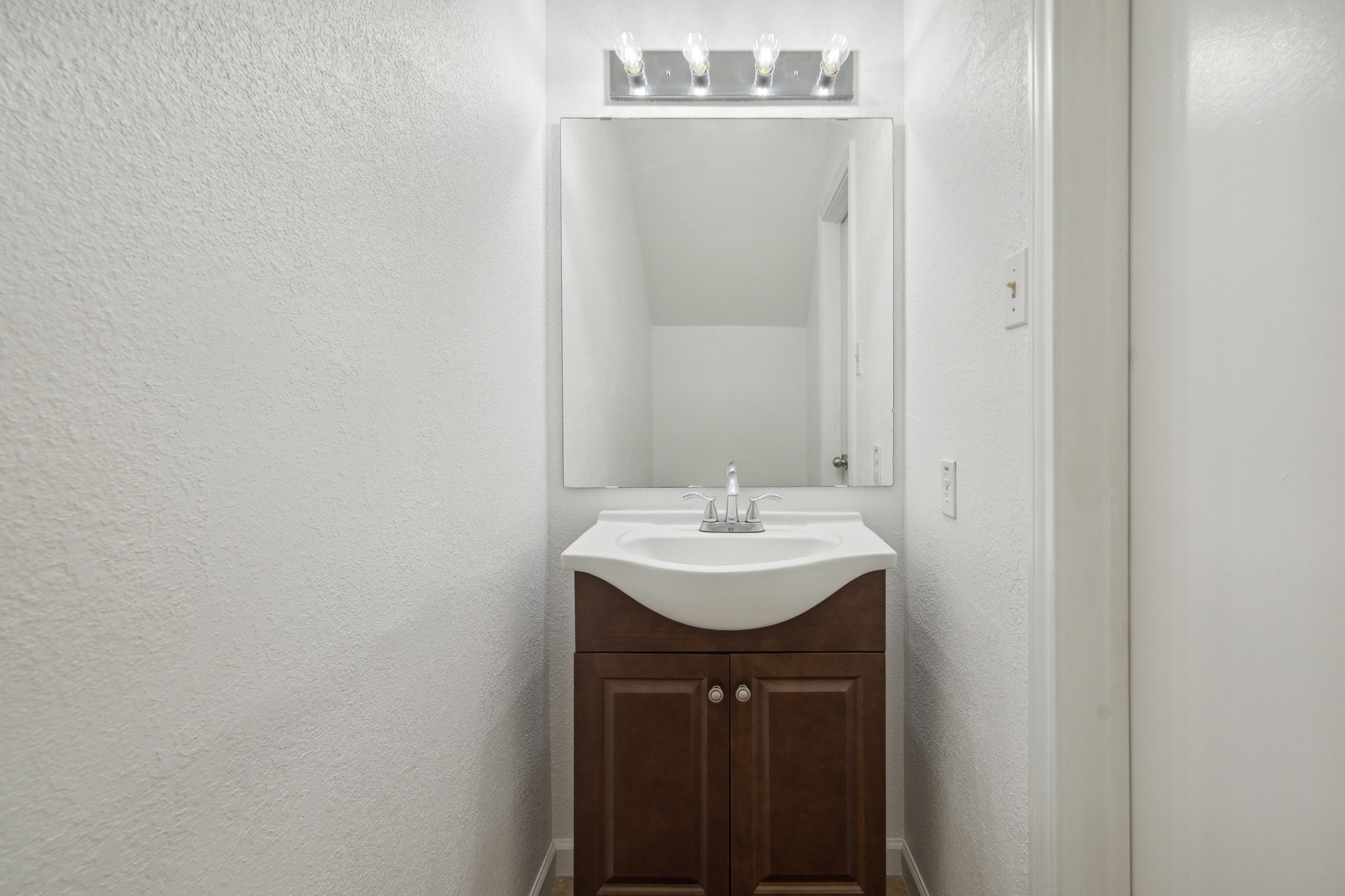 3606 Ocee Street Houston, TX 77063 - Photo 11 of 16 a bathroom with a sink a mirror and vanity