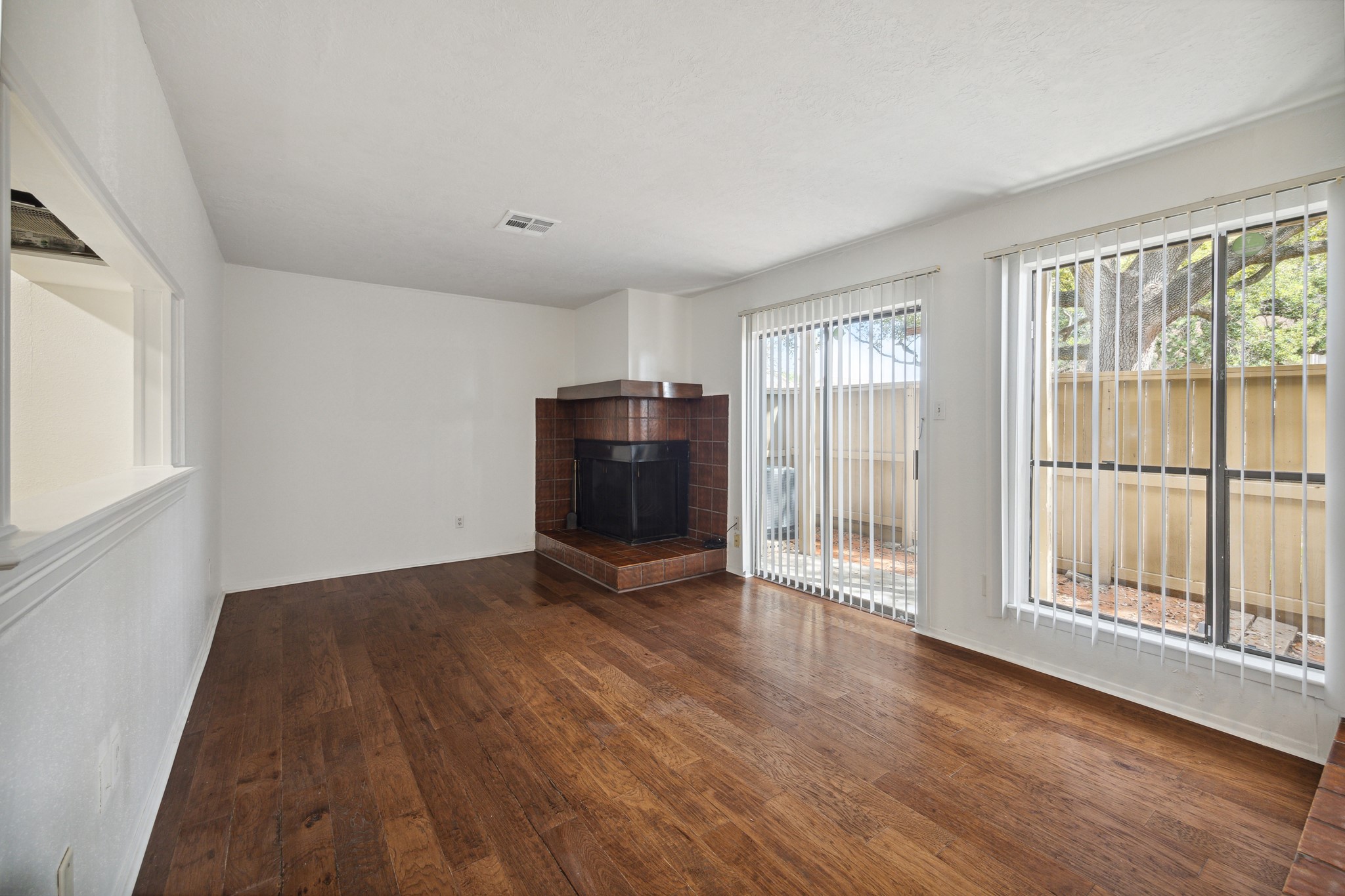 3606 Ocee Street Houston, TX 77063 - Photo 4 of 16 an empty room with wooden floor and windows
