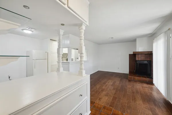 a view of kitchen with refrigerator and window