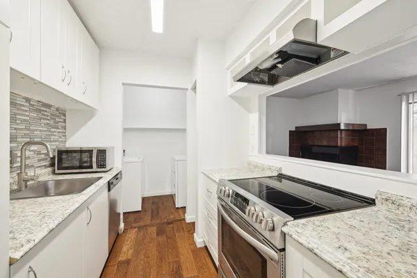 a kitchen with a stove and a microwave