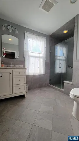 a bathroom with a sink a toilet and mirror