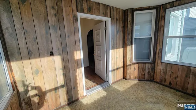 a view of a porch with wooden floor and windows