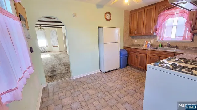 a kitchen with stainless steel appliances granite countertop a stove a refrigerator and a oven