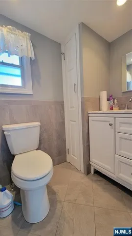 a white toilet sitting next to a bathroom sink