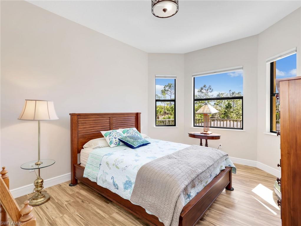 3160 27th Avenue Southwest Naples, FL 34117 - Photo 33 of 43 a bedroom with a bed and a window