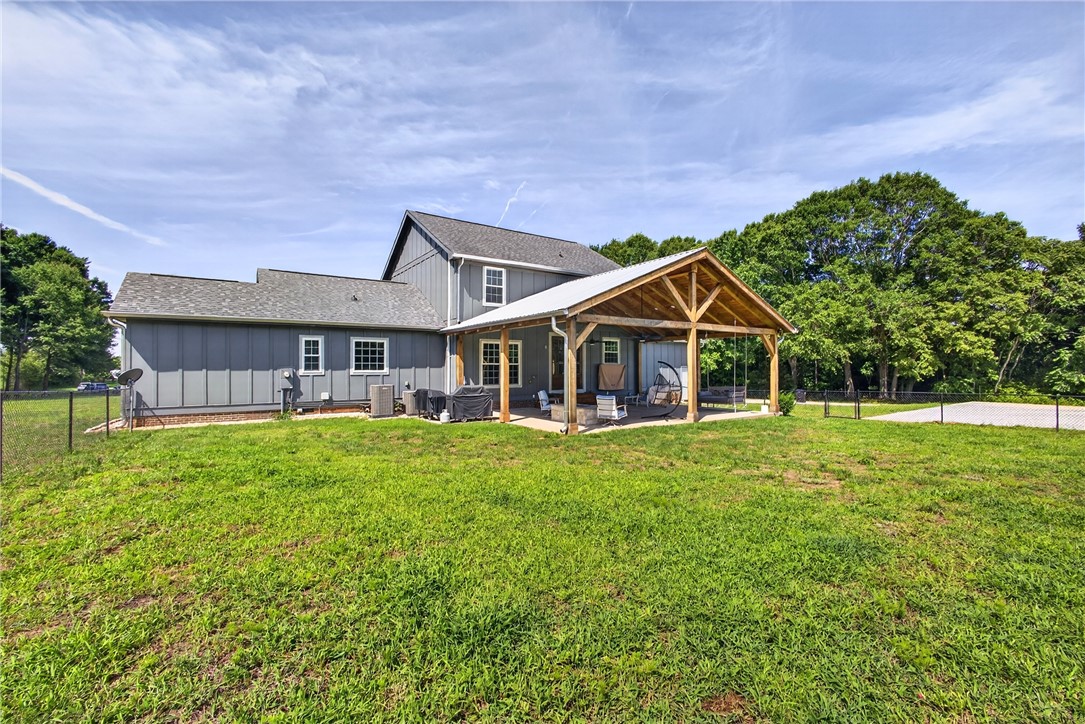5016 Copeland Road Belton, SC 29627 - Photo 37 of 45 A spacious backyard with an inviting covered patio, ideal for outdoor leisure.
