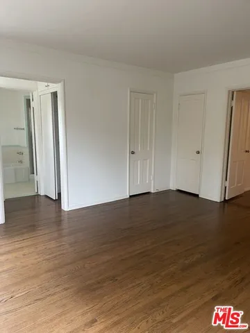 a view of an empty room and wooden floor