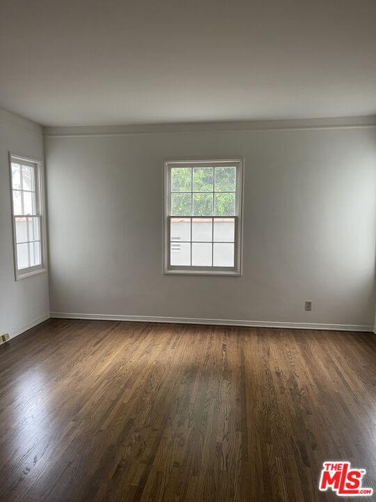 1292 Devon Avenue, Unit 1294 Los Angeles, CA 90024 - Photo 12 of 12 an empty room with wooden floor and windows
