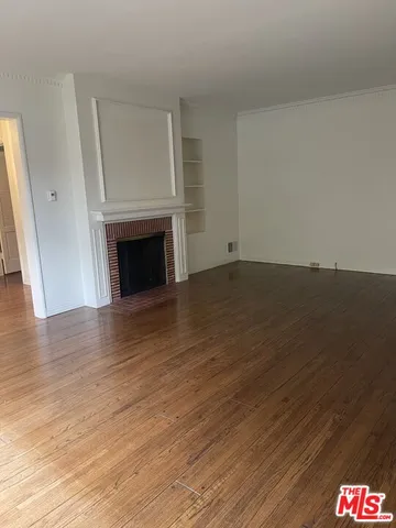 a view of an empty room and wooden floor