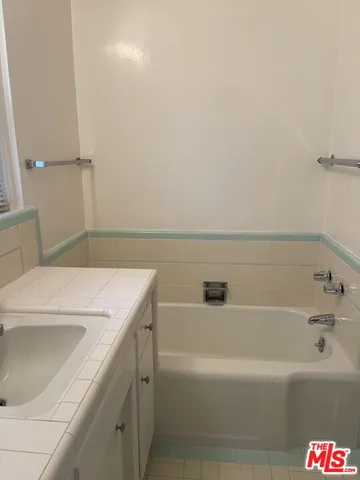 a bathroom with a bathtub and a toilet