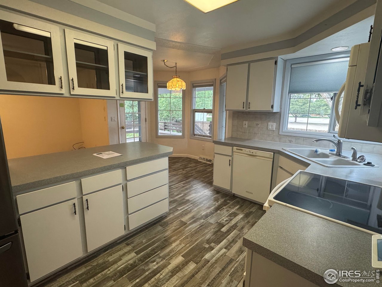 4927 West 6th Street Greeley, CO 80634 - Photo 14 of 34 a kitchen with a sink stove and cabinets