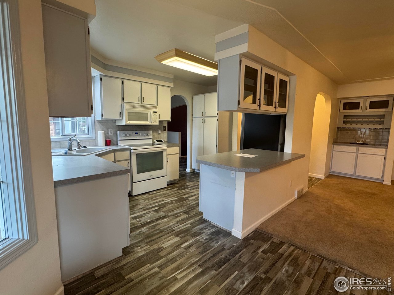 4927 West 6th Street Greeley, CO 80634 - Photo 15 of 34 a kitchen with stainless steel appliances a stove top oven and a refrigerator