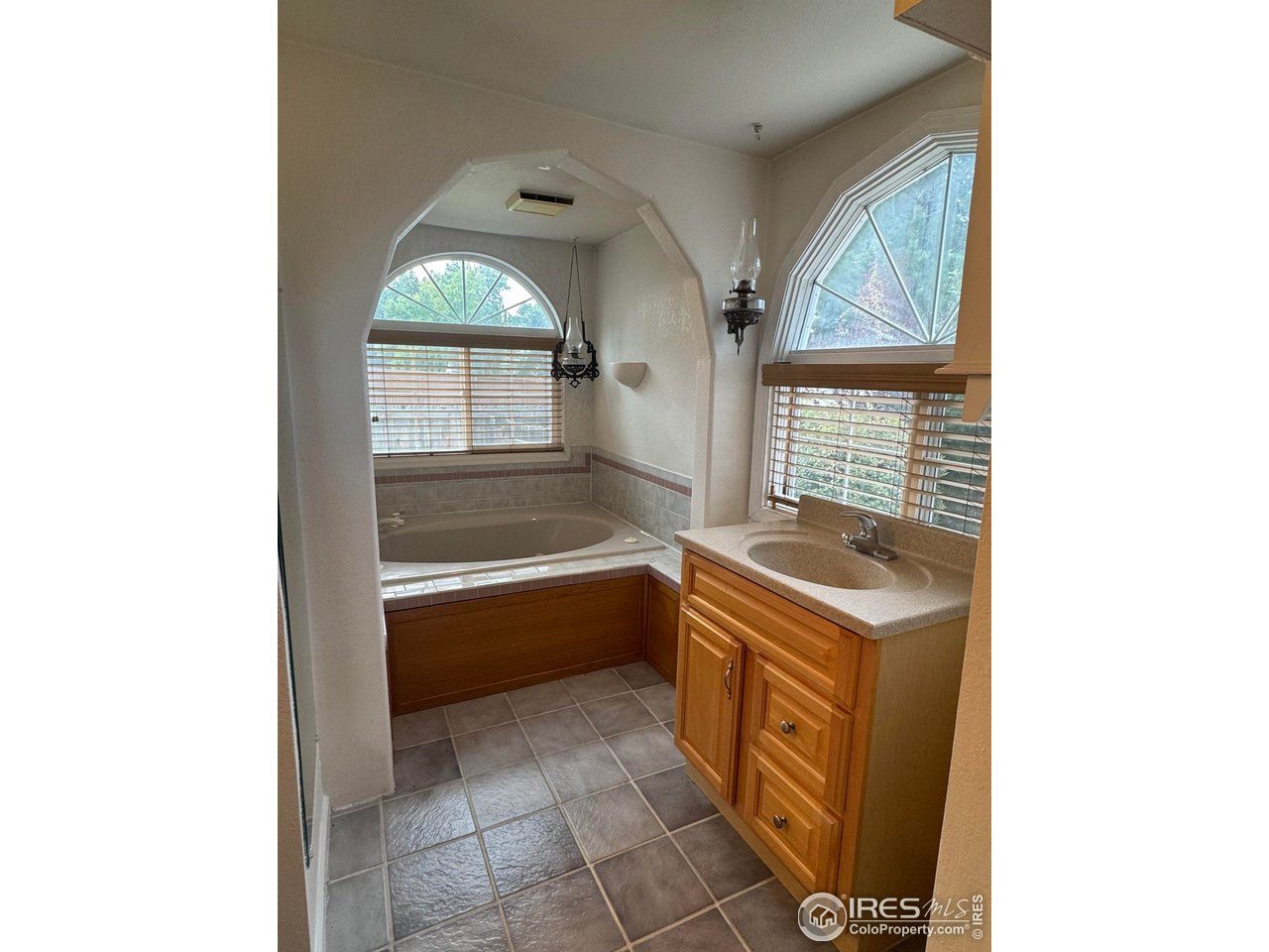 4927 West 6th Street Greeley, CO 80634 - Photo 28 of 34 a bathroom with a sink a bathtub and a vanity