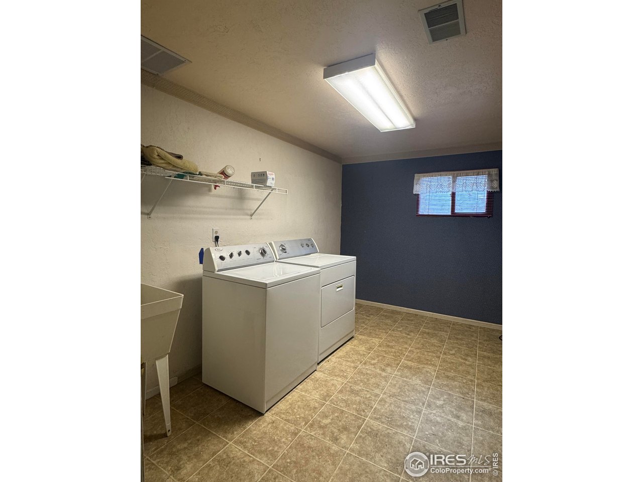 4927 West 6th Street Greeley, CO 80634 - Photo 29 of 34 a utility room with cabinets washer and dryer