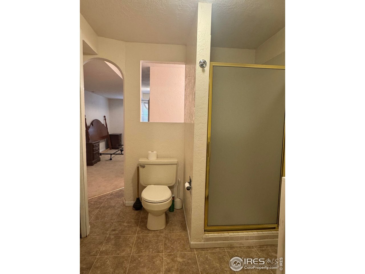 4927 West 6th Street Greeley, CO 80634 - Photo 30 of 34 a bathroom with a toilet a sink and a mirror