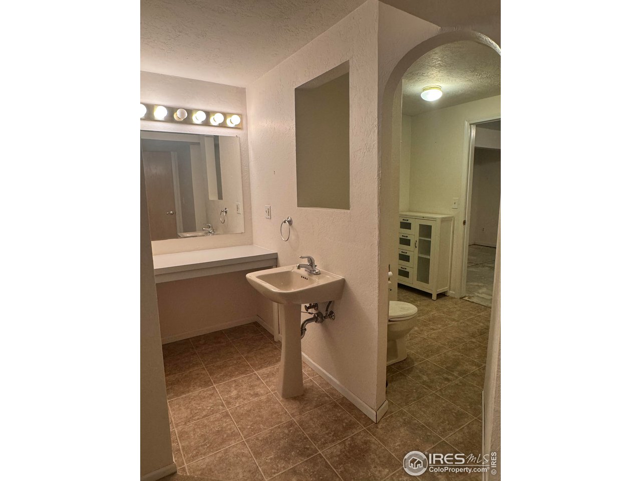 4927 West 6th Street Greeley, CO 80634 - Photo 34 of 34 a bathroom with a sink a toilet and mirror