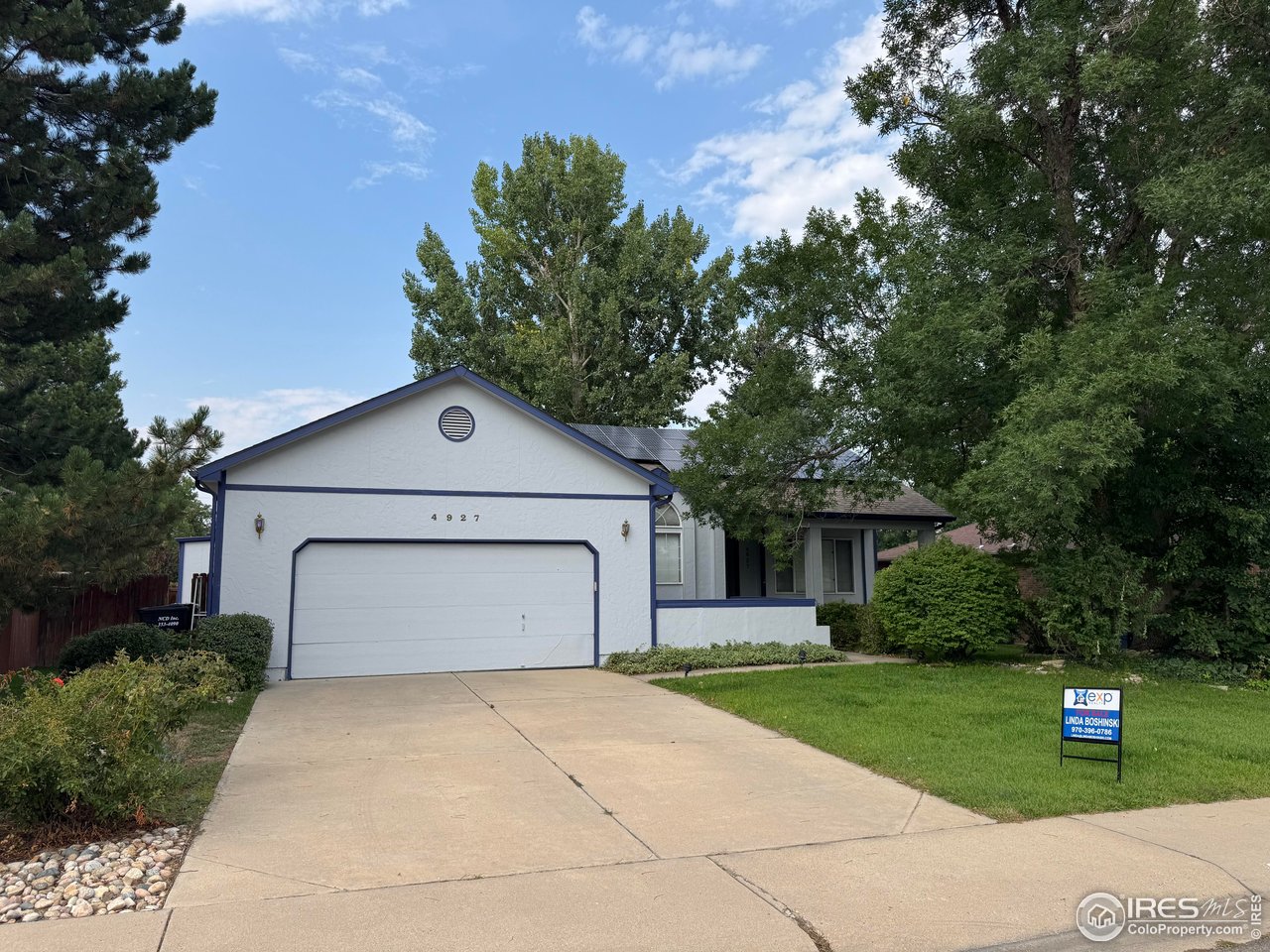 4927 West 6th Street Greeley, CO 80634 - Photo 5 of 34 a front view of a house with a yard and garage