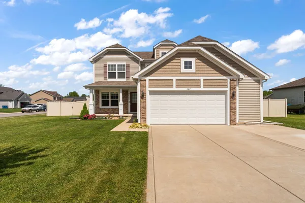 a front view of a house with a yard
