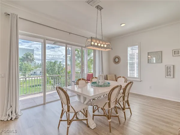 a view of a dining room with furniture wooden floor and chandelier