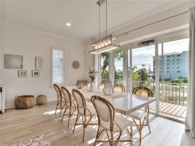 a dining room with furniture a chandelier and wooden floor