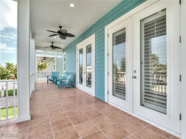 a view of a porch with a table and chairs