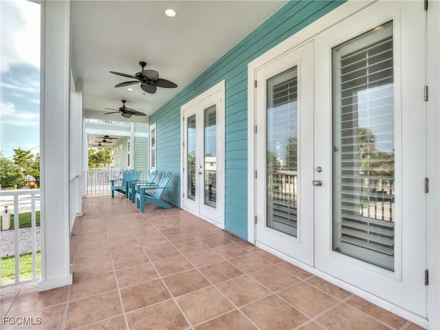 a view of a porch with a table and chairs
