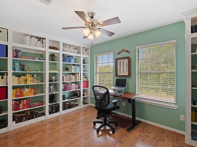 a view of a workspace with a bookshelf