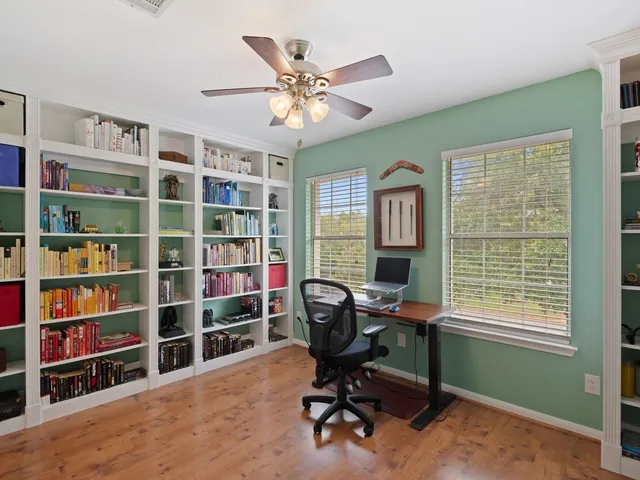a view of a workspace with a bookshelf