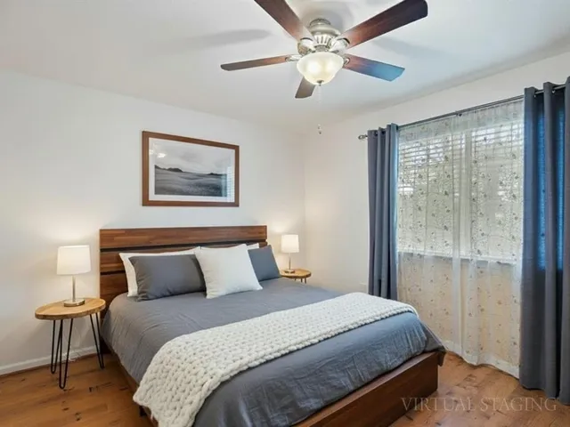 a bedroom with a large bed and a chandelier
