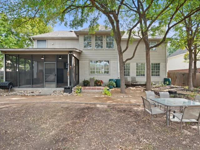 a view of a house with backyard porch and sitting area