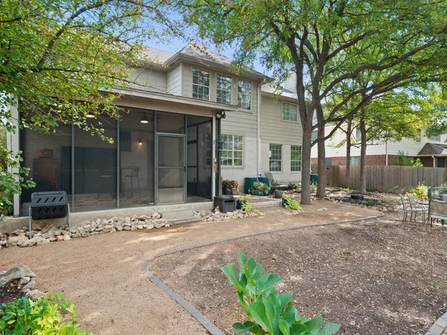 a view of a house with backyard and sitting area