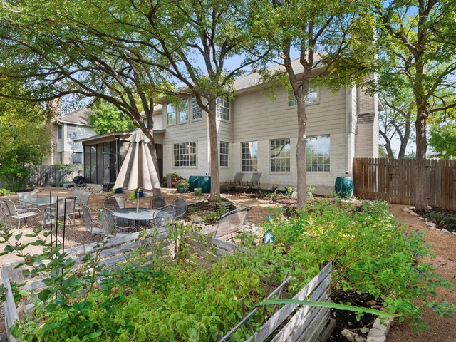 a view of backyard of house with outdoor seating and green space