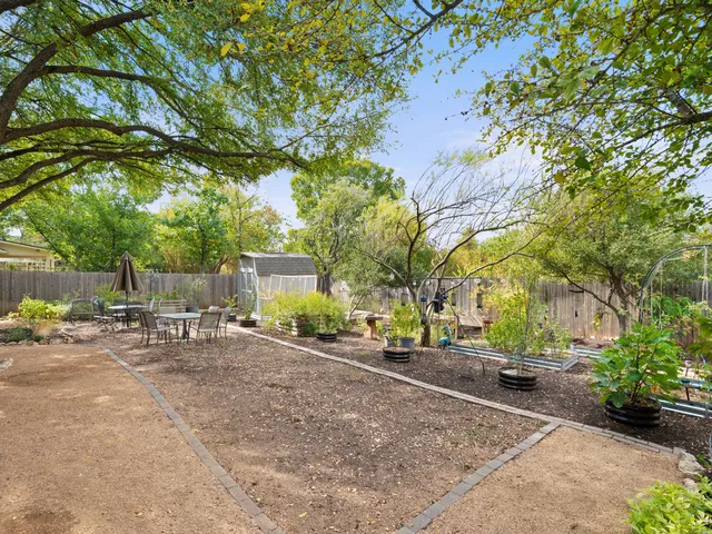 a row of palm trees in front of a house
