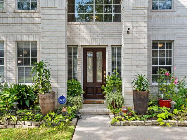 a front view of a house with potted plants