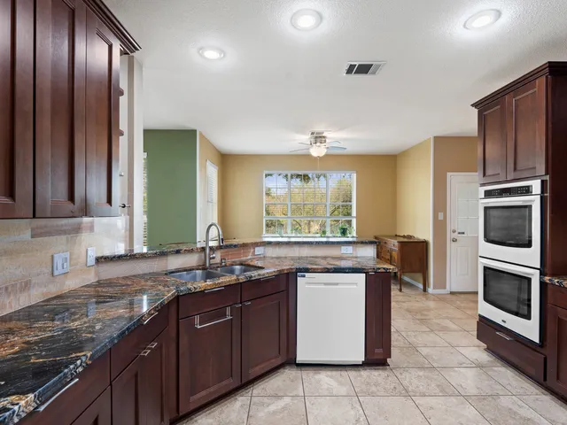 a kitchen with a sink stove and microwave