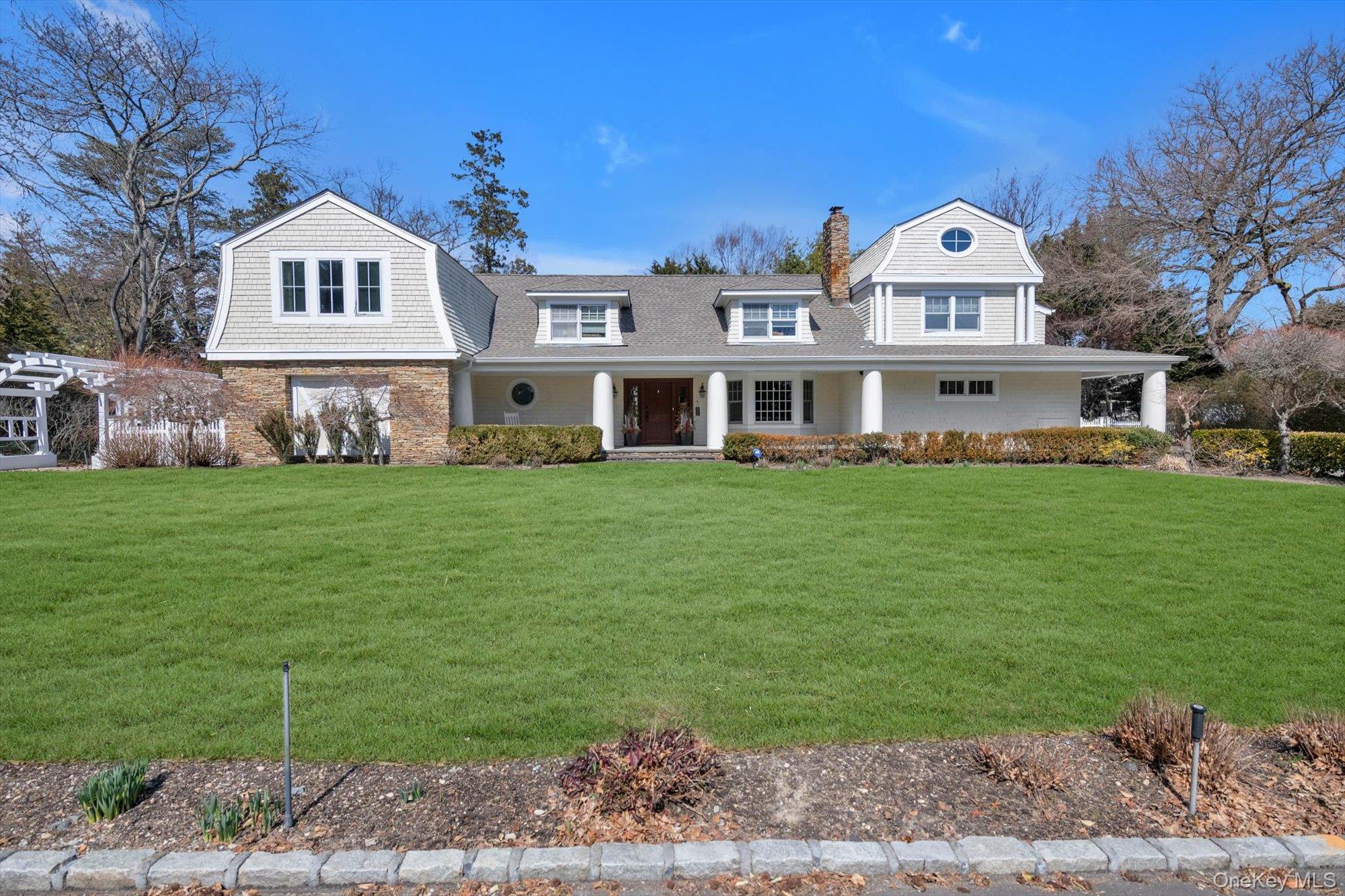 a front view of a house with a garden