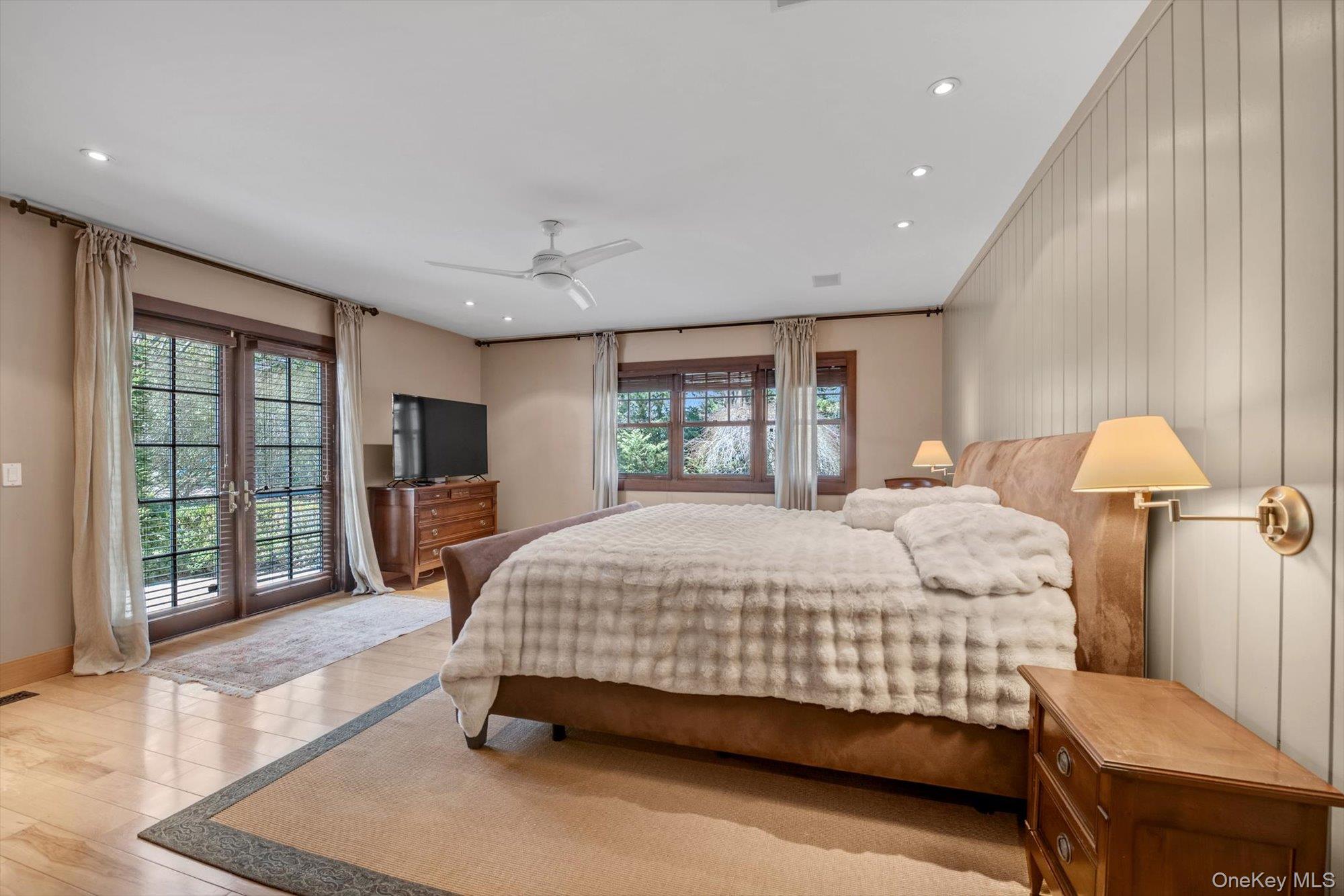 254 Adams Road Hewlett Harbor, NY 11557 - Photo 13 of 34 a bedroom with a large bed and a tv
