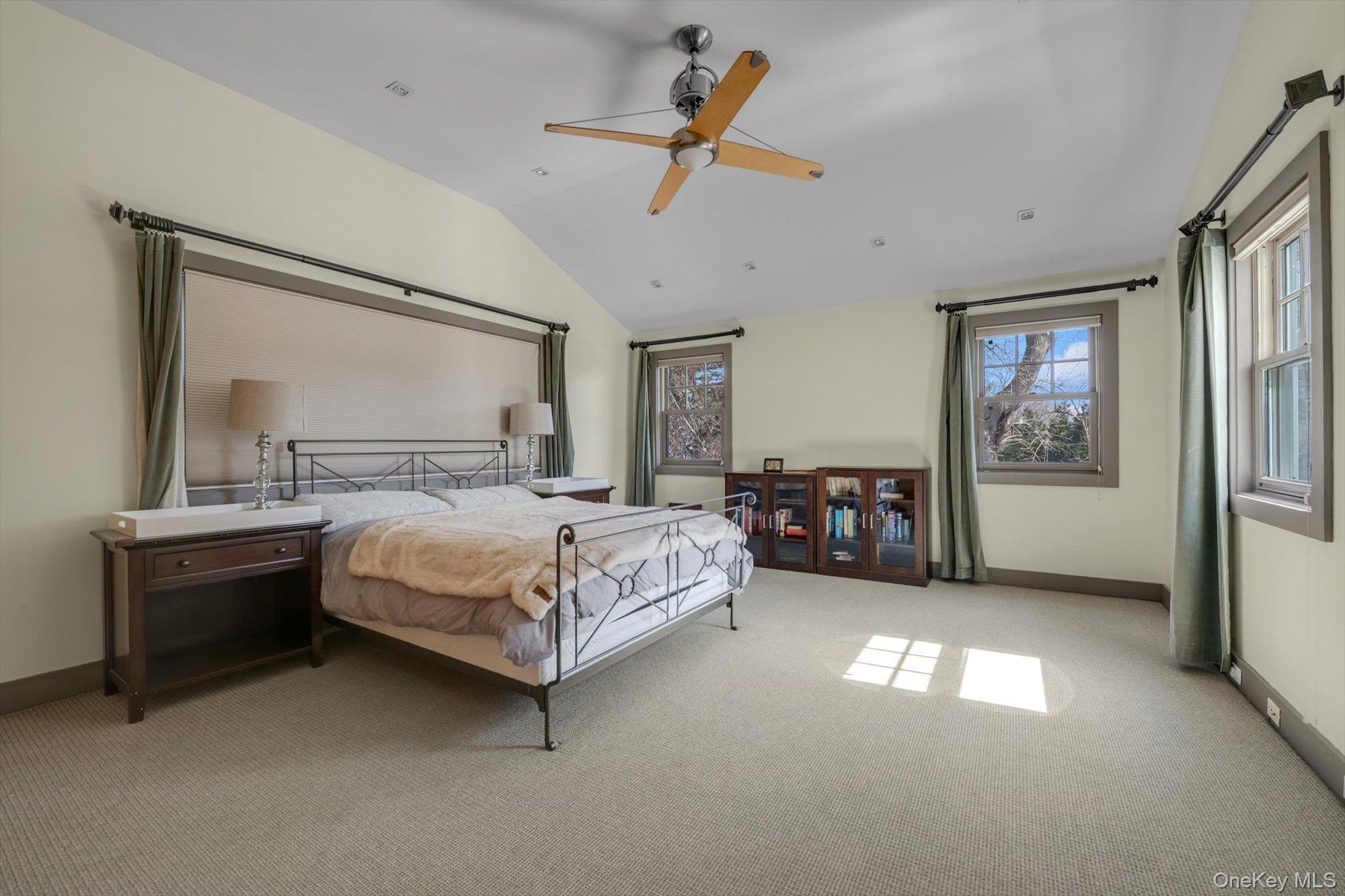 254 Adams Road Hewlett Harbor, NY 11557 - Photo 19 of 34 a bedroom with a bed and a chandelier