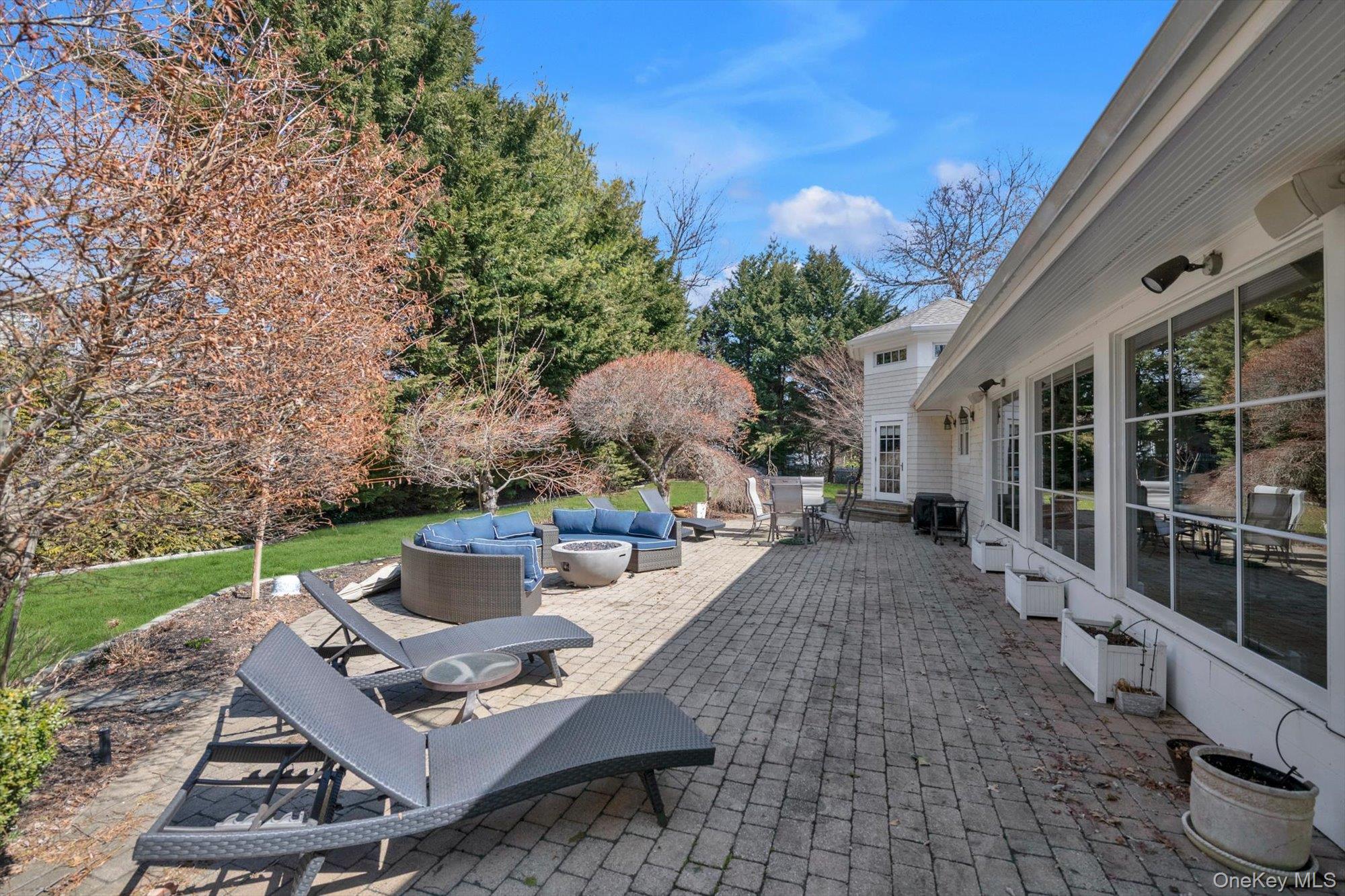 254 Adams Road Hewlett Harbor, NY 11557 - Photo 26 of 34 a view of a patio with table and chairs and potted plants