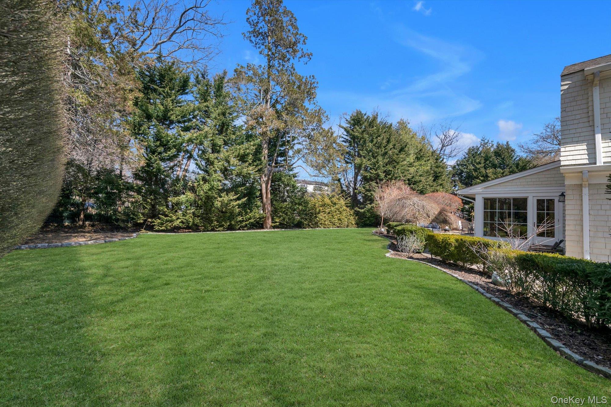 254 Adams Road Hewlett Harbor, NY 11557 - Photo 29 of 34 a backyard of a house with lots of green space