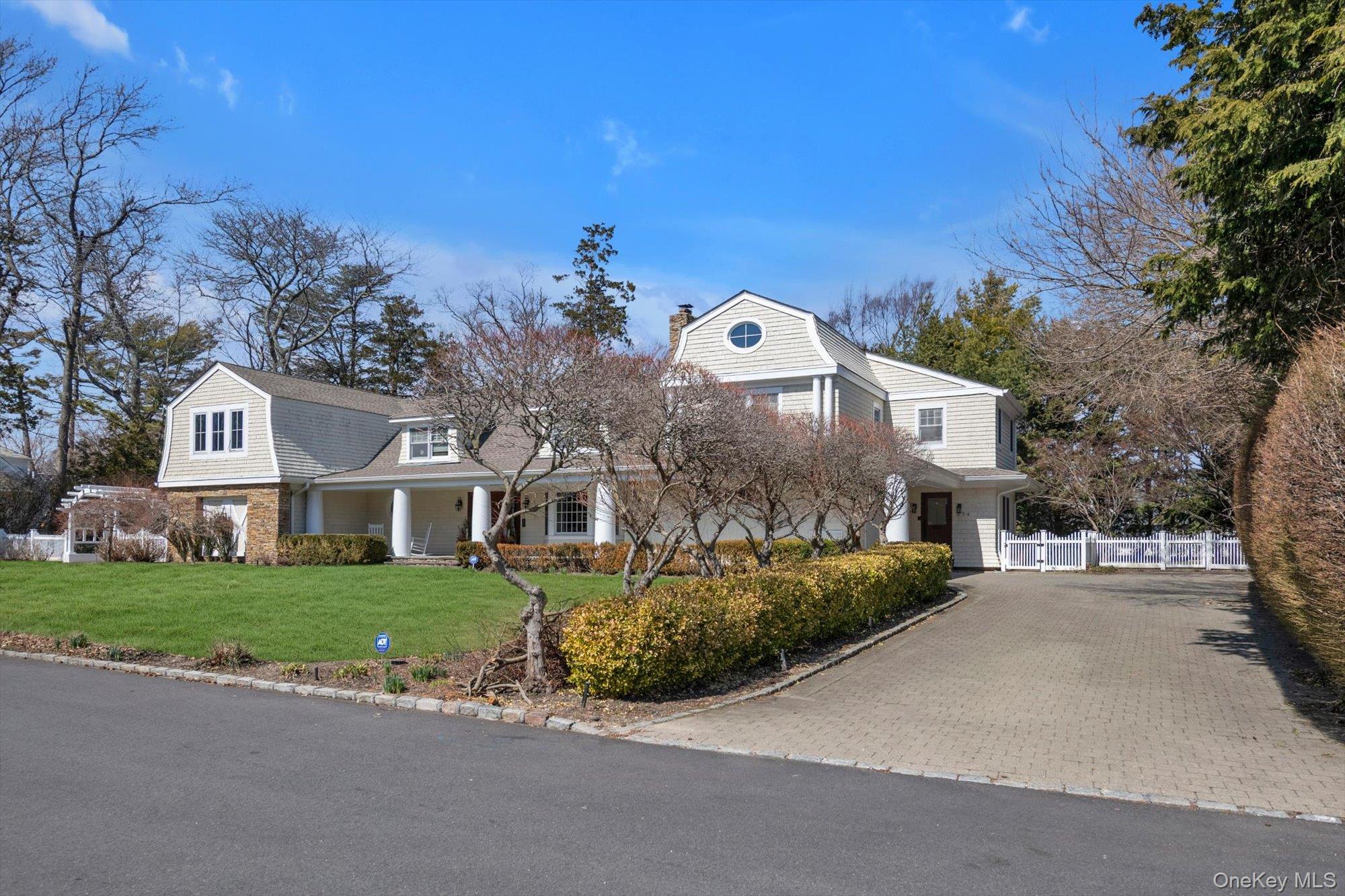 254 Adams Road Hewlett Harbor, NY 11557 - Photo 30 of 34 a front view of a house with a garden and yard