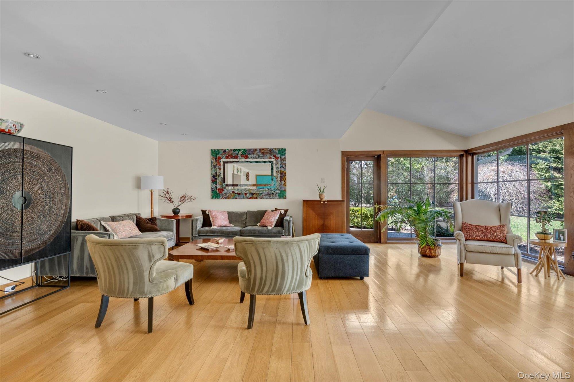 254 Adams Road Hewlett Harbor, NY 11557 - Photo 3 of 34 a living room with furniture wooden floor and a floor to ceiling window