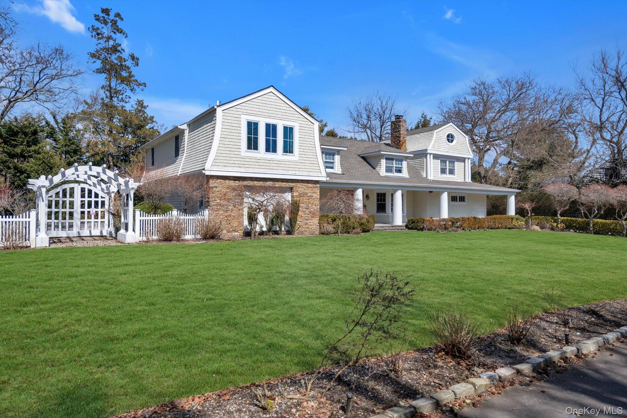 254 Adams Road Hewlett Harbor, NY 11557 - Photo 31 of 34 a front view of a house with garden