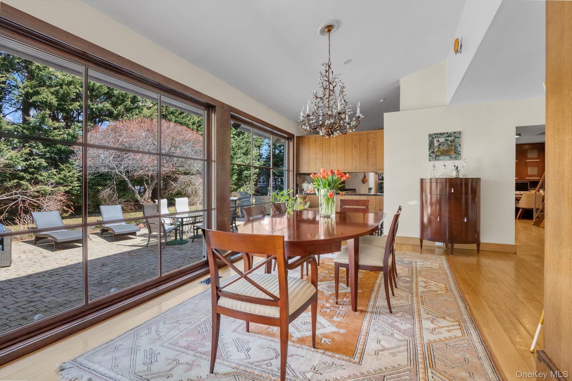 254 Adams Road Hewlett Harbor, NY 11557 - Photo 6 of 34 a dining room with furniture a chandelier and wooden floor