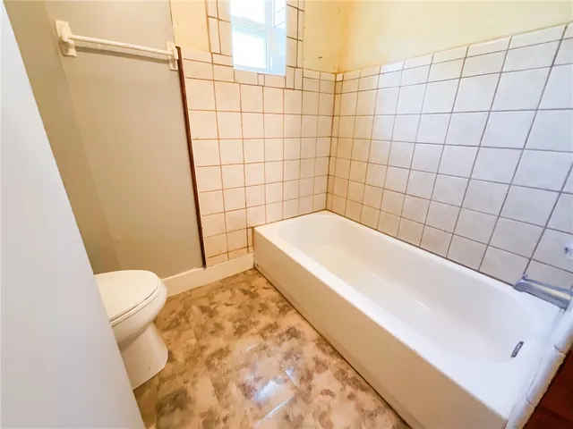 a bathroom with a bathtub and toilet