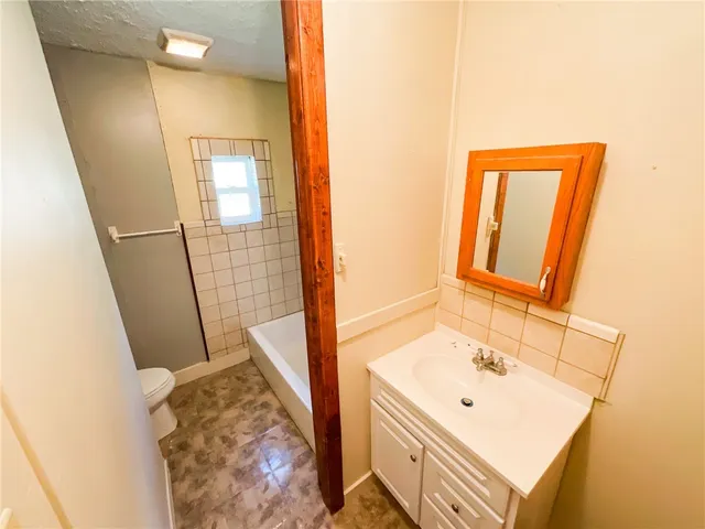 a bathroom with a sink a mirror and a shower