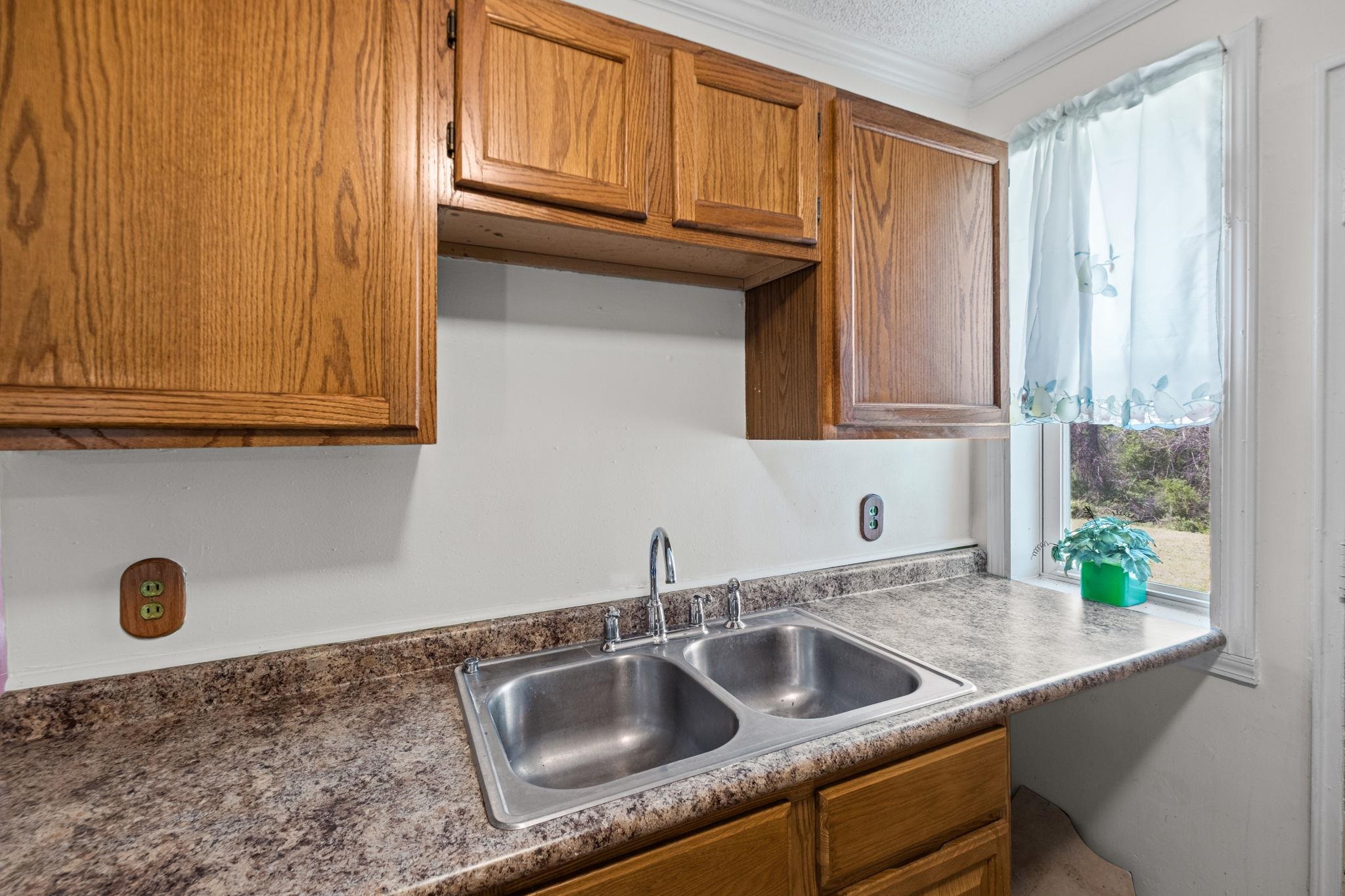 668 Westview Road Memphis, TN 38109 - Photo 10 of 27 Kitchen with wood finish cabinets and crown molding