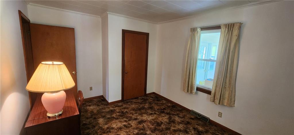 1677 Mercer Road Ellwood City, PA 16117 - Photo 16 of 22 a bedroom with a bed and a window